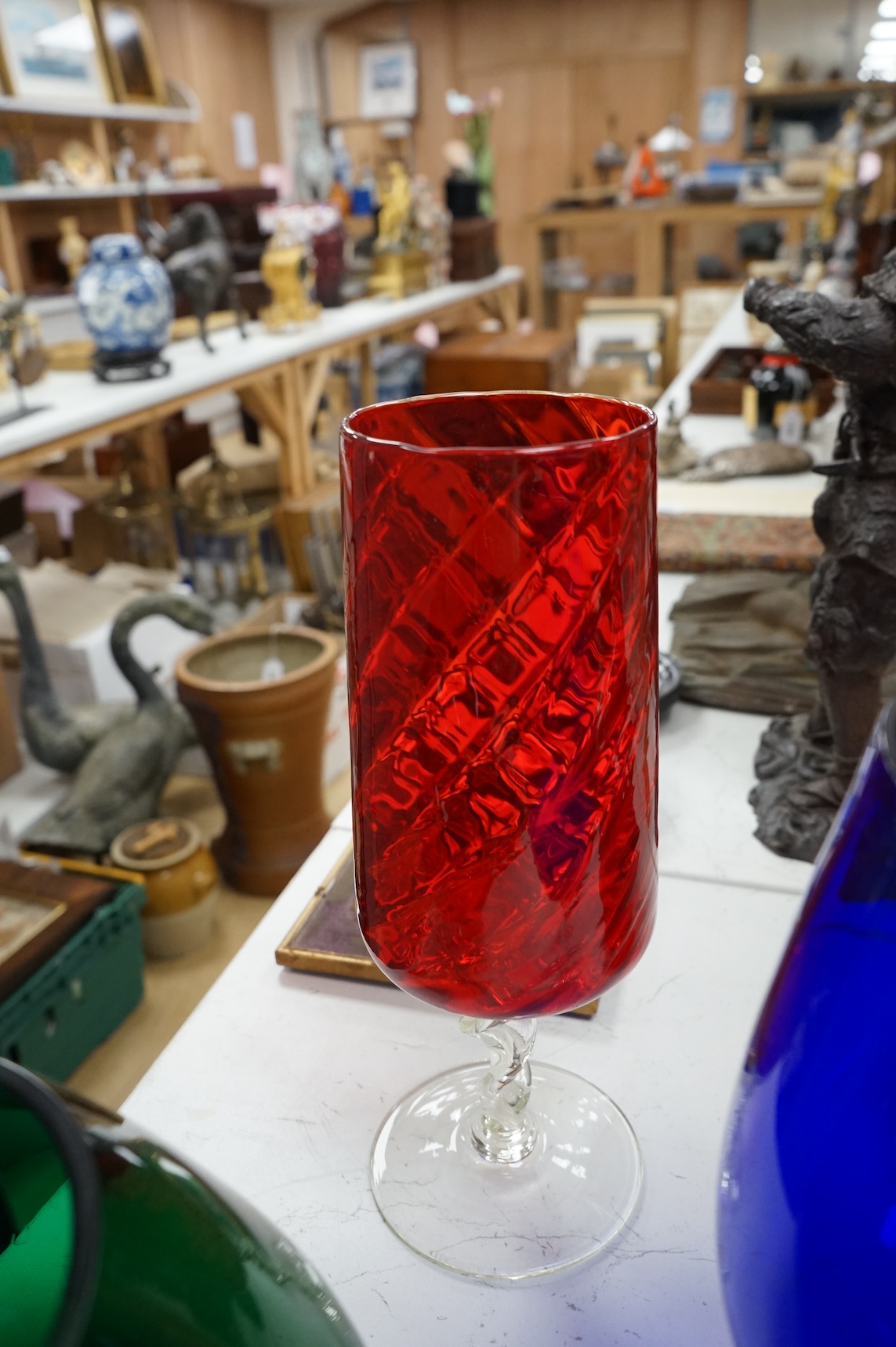 Five pieces of mid-century coloured glassware, to include a jug and an oversized brandy balloon, largest 48cm high